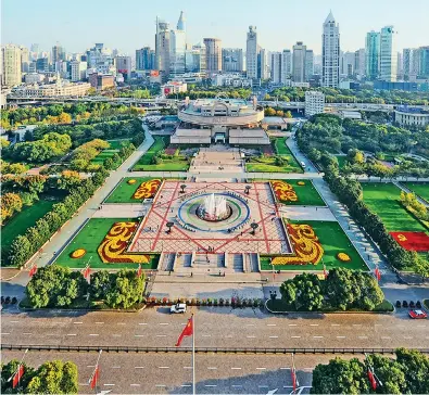  ?? ?? Featuring a sunken circular fountain, a central plaza called Light of the Huangpu River is at the heart of People’s Square, which has a symmetric design.