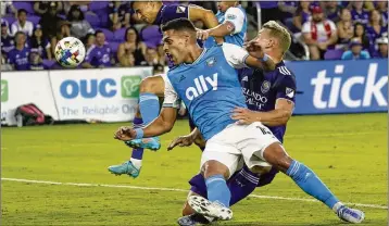  ?? JOHN RAOUX/AP ?? Daniel Rios, then with Charlotte, gets tangled up with Robin Jansson of Orlando City in a 2022 match. Atlanta United manager Gonzalo Pineda expects Rios to bring “some energy, some profession­alism” to the team.