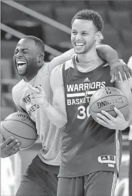 ?? Ben Margot
Associated Press ?? STEPHEN CURRY, right, is an NBA star with an upside in personal charm, too, as he keeps practice lightheart­ed with Golden State teammate Draymond Green.