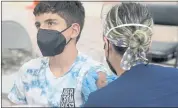  ?? MARTA LAVANDIER — THE ASSOCIATED PRESS ?? Andres Veloso, 12, gets the first dose of the Pfizer COVID-19 vaccine on Monday in Miami. Florida is reporting a surge of COVID-19 cases caused by the highly contagious delta variant.