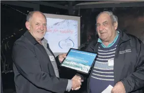  ?? PHOTO: GREGOR RICHARDSON ?? Honour . . . Search and Rescue district coordinato­r Brian Benn (left) presents Keith Simon with an outstandin­g service award at the Marine SAR awards at Careys Bay Hotel last night.