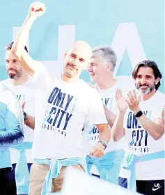  ??  ?? Pep Guardiola (left) on stage during the parade.