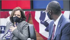  ?? PAUL SANCYA — THE ASSOCIATED PRESS ?? Above: Democratic vice presidenti­al candidate Sen. Kamala Harris, D-Calif., listens to Michigan Lt. Governor Garlin Gilchrist II at Headliners Barbershop in Detroit on Tuesday. Below: Harris, D-Calif., speaks as Reverend Wendell Anthony, left, and Michigan Lt. Gov. Garlin Gilchrist II listen at Headliners Barbershop in Detroit on Tuesday.