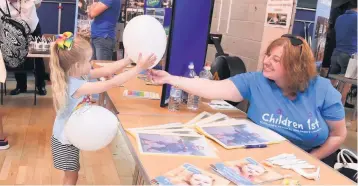  ??  ?? Balloon fun The putting children first stall