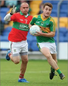  ??  ?? Mark Miley of Laragh is tracked by Jason Devlin of Rathnew.