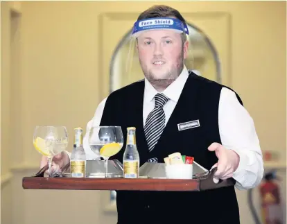  ?? IAN COOPER ?? Staff member Harry Parmley delivers room service at St George’s Hotel, Llandudno