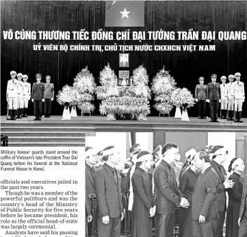  ??  ?? Military honour guards stand around the coffin of Vietnam’s late President Tran Dai Quang before his funeral at the National Funeral House in Hanoi. Vietnam’s Prime Minister Nguyen Xuan Phuc shares a moment with family members after he paid respects to Vietnam’s late President. — Reuters photos