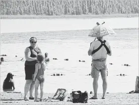  ?? MARK THIESSEN THE ASSOCIATED PRESS ?? People try to beat the heat Goose Lake in Anchorage, Alaska, on July 5. The official temperatur­e on July 4 reached 90 degrees F for the first time in Anchorage.