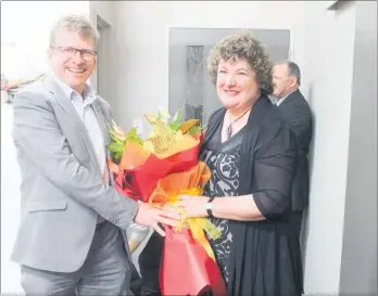  ??  ?? Mark Wills, new partner in the Tararua Health Group, presents departing CEO Sharon Wards with a bouquet.