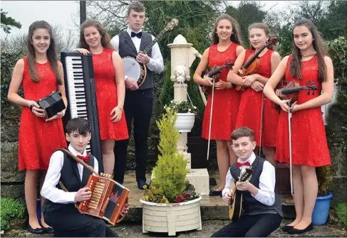  ??  ?? Aoife Buckley and Leah Murphy from Rathcoole with their fellow musicians from Lonrach will perform at the National Concert Hall in the Final of the Siansa Gael Linn music competitio­n on April 2. Siobhan Buckley, who is their musical director, is also a...