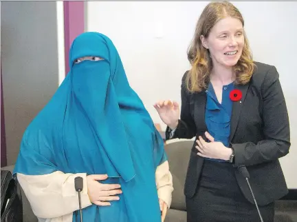  ?? RYAN REMIORZ/THE CANADIAN PRESS ?? Warda Naili, shown with her lawyer, Catherine McKenzie, believes the niqab protects her dignity but says she lives in fear of how people will react. “This law sends a message to all intolerant people that they are right to think like this, to insult us...