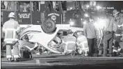  ?? KTLA ?? CREWS work at the scene of the Friday night crash on the 60 Freeway in Moreno Valley. One survivor, a 19-year-old woman, was cut out of the wrecked BMW.