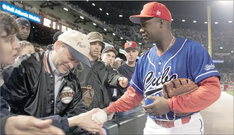  ?? — DIGITAL IMAGE FILES ?? Cuba’s Omar Linares signs autographs during an exhibition game in 1999 against the Orioles at Camden Yards in Baltimore.