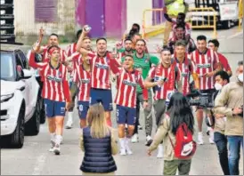  ?? AFP ?? Atletico players celebrate outside the Jose Zorilla stadium after winning La Liga.