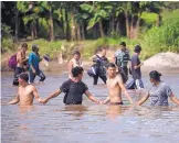  ?? SANTIAGO BILLY/ASSOCIATED PRESS ?? Central American migrants bound for the U.S. border wade across the Suchiate River, which separates Guatemala from Mexico, in Tecun Uman, Guatemala, on Monday.