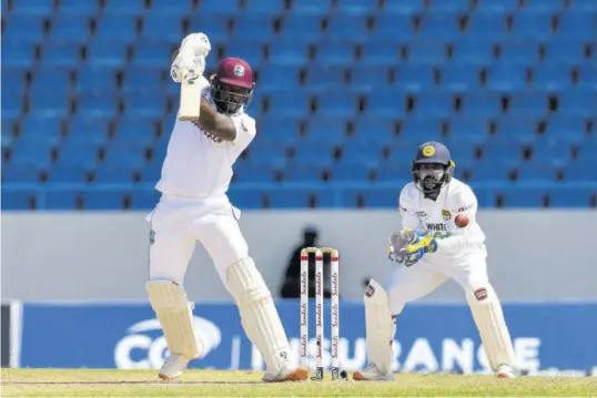  ??  ?? West Indies batsman Kyle Mayers (left) bats as Sri Lanka’s Niroshan Dickwella watches.