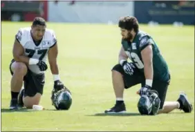 ?? CHRIS SZAGOLA — THE ASSOCIATED PRESS ?? Defensive tackle Destiny Vaeao, left, talks with guard Isaac Seumalo, right, during a break in practice Tuesday.