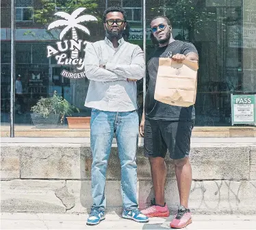  ?? AUNTY LUCY’S ?? Owners Chieff Bosompra, left, and chef Adrian Forte stand in front of Aunty Lucy’s, a new burger joint that just opened in Parkdale. The restaurant celebrates Ghanaian culture.