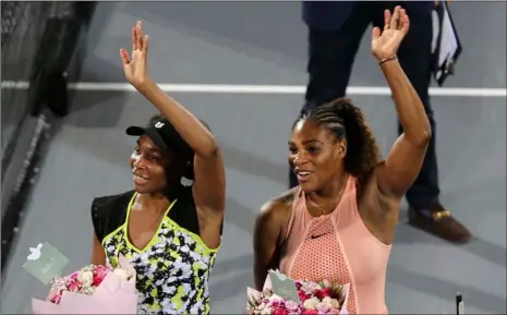  ?? AP Photo/Kamran Jebreili ?? In this 2018 file photo, Venus Williams (left) celebrates winning against her sister Serena (right) after a match on the opening day of the Mubadala World Tennis Championsh­ip in Abu Dhabi, United Arab Emirates.