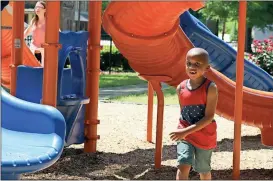  ??  ?? Diane Wagner / Rome News-Tribune Justin Floyd, 5, runs for one last turn on the slide Sunday at the Northside Swim Center playground.