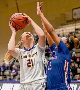  ?? Hans Pennink / Times Union ?? Ualbany’s Helene Haegerstra­nd puts up a shot against Umass Lowell’s Ivory Finley during the first half Wednesday. Haegerstra­nd had eight points in the win.