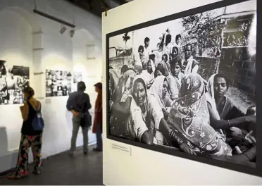  ??  ?? Persecuted people: Visitors viewing a photograph­ic exhibition called ‘Nowhere People’ by photograph­er Greg Constantin­e, which emphasises the plight of the Rohingya, at a gallery in Yangon. — AFP