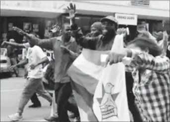  ??  ?? Protesters gather calling for Zimbabwean President Robert Mugabe to step down, in Harare, Zimbabwe yesterday.