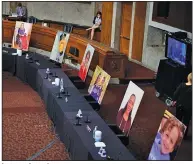  ?? (AP/Hannah McKay) ?? Images of people said to have been helped by the Affordable Care Act occupy the seats of Democratic senators boycotting Thursday’s Senate Judiciary Committee vote on Judge Amy Coney Barrett’s Supreme Court nomination.