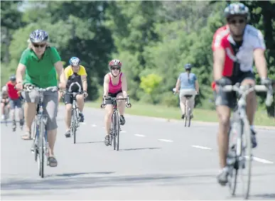  ?? JUSTIN TANG ?? Cyclists ride along Sir John A. Macdonald Parkway on a Sunday morning when parts of the road are closed to vehicles. The NCC proposes changes to traffic flows along a section of the western parkway and letter writers aren’t impressed.