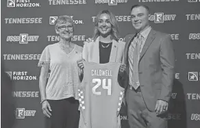  ?? HANNAH MATTIX/NEWS SENTINEL ?? Kim Caldwell, center, stands with her mother and husband, Justin Caldwell, a former assistant coach for Marshall men's basketball, after being welcomed as the University of Tennessee's Lady Vols coach on Tuesday in Knoxville.