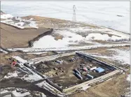  ?? AP PHOTO BY TOM STROMME ?? This Feb. 13 aerial file photo shows the site where the final phase of the Dakota Access pipeline will take place with boring equipment routing the pipeline undergroun­d and across Lake Oahe to connect with the existing pipeline in Emmons County near...
