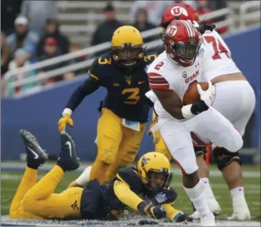  ?? ROSE BACA — THE DALLAS MORNING NEWS VIA AP ?? Utah running back Zack Moss runs the ball against West Virginia during the first half Dec. 26 in Dallas.