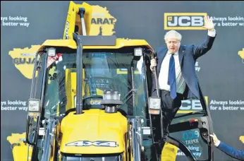  ?? AFP ?? UK PM Boris Johnson waves from an excavator during his visit to the JCB factory in Vadodara.