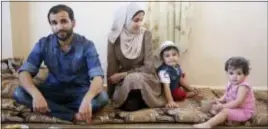  ??  ?? Mohammad al-Haj Ali, 28, left, his wife Samah Hamidi, 25, their son Khaled, 2, and their niece Sara, 1, pose for a photo during an interview in their home in Irbid, Jordan on Thursday The family fled the Syrian war in 2012 for Jordan and was in the...