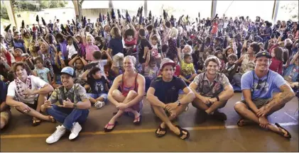  ??  ?? Pro surfers Torsten Durkan (front from left), Ty Simpson-Kane, Paige Alms, Kai Lenny, Jesse Richman and Albee Layer pose with Haiku Elementary School students, who received their new water canteens Friday.