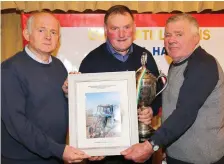  ??  ?? Andy O’Connor and Willie Stokes of Kilbrin Ploughing Associatio­n making a presentati­on to Michael Hannon, in recognitio­n of his success at the National Ploughing Championsh­ips in Carlow.