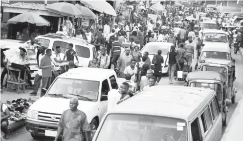  ?? PHOTO: BENEDICT UWALAKA ?? Residents make last minute shopping at Ikeja, Lagos yesterday.