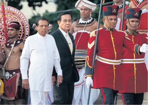  ??  ?? Sri Lankan President Maithripal­a Sirisena, left, accompanie­s Prime Minister Prayut Chan-o-cha at the Presidenti­al Secretaria­t in Colombo, Sri Lanka on Thursday.