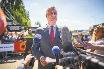  ?? Phil Nijhuis / Associated Press ?? Kosovo President Hashim Thaci speaks to reporters as he arrives at The Hague in the Netherland­s. Prosecutor­s have charged him with crimes against humanity and war crimes.