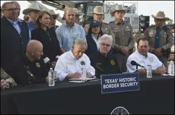  ?? ASSOCIATED PRESS FILES ?? Texas Gov. Greg Abbott signs three bills into law Dec. 18 to broaden his border security plans and add funding for more infrastruc­ture to deter illegal immigratio­n. The Justice Department on Wednesday sued Texas over a new law that would allow police to arrest migrants who enter the US illegally.