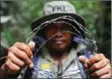  ?? CHAIDEER MAHYUDDIN/AFP ?? An ranger holds barbed wire removed from traps set up by poachers to capture bears and tigers in the Leuser Ecosystem rainforest.