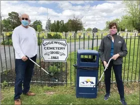  ?? PHOTO COURTESY OF CATHY SKITKO ?? Edgewood Cemetery board members Andrew Monastra, left, and Cathy Skitko show off the trash grabbers being sold to raise money for the maintenanc­e of the historic burial ground.