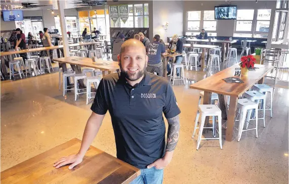  ?? GREG SORBER/JOURNAL ?? Jotham Michnovicz, director of operations at Bosque Brewing Co., stands in the expanded portion of Bosque’s Nob Hill Public House, which took over a space formerly occupied by WisePies Pizza & Salad