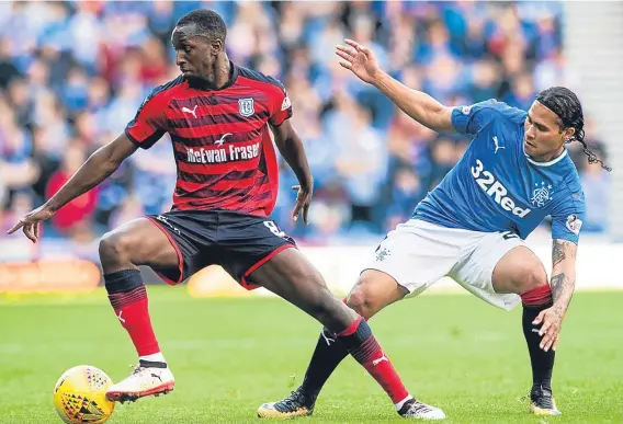  ??  ?? Glen Kamara turns away from Gers’ goalscorer Carlos Pena in Saturday’s 4-1 loss at Ibrox as Dundee continue to hunt for their first league win.