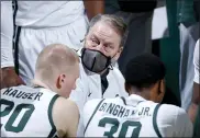  ?? AL GOLDIS — THE ASSOCIATED PRESS ?? Michigan State coach Tom Izzo, center, talks to players during a timeout in the second half of an NCAA college basketball game against Indiana on Tuesday, in East Lansing. Michigan State won 64-58.