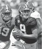  ?? GARY COSBY/TUSCALOOSA NEWS ?? Alabama quarterbac­k Bryce Young rolls away from pressure during the Crimson Tide’s spring game Saturday at Bryant-denny Stadium in Tuscaloosa, Ala.