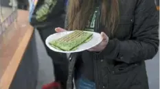  ?? ?? Slippery Rock student Bri Hunt holds a spinach wrap she ordered for lunch.