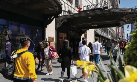  ?? Calla Kessler / Bloomberg ?? The Macy’s flagship store is seen Wednesday in the Herald Square area of New York. The country’s largest banks said spending on credit cards surged in the first quarter, allaying fears that consumers would cut back as government aid dried up.