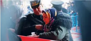  ?? Associated Press ?? Gulay Kalo cries over the coffin of her husband Ali Kalo during his funeral procession in Istanbul.