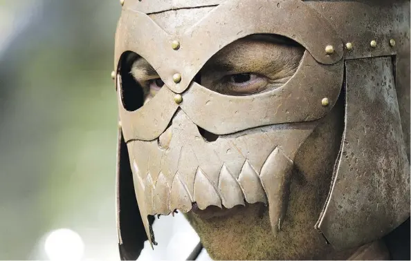  ?? PHOTOS: DAVID BLOOM ?? Dressed as an orc, assistant superinten­dent for Elk Island Catholic Schools Paul Corrigan takes part in a battle at Our Lady of the Angels school as part of a practice exam in Fort Saskatchew­an Thursday. Science teacher Scott Hebert transforme­d the...